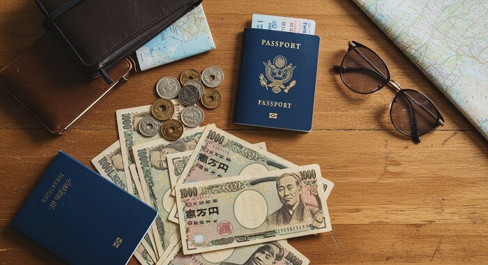 Japan travel guide budget planning with yen banknotes coins passport and travel essentials